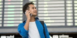 Man calling phone in airport